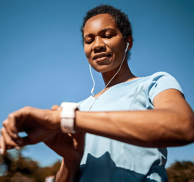 woman checking heart rate on smart watch