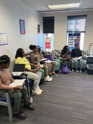 WIN Network participants and their support persons engage in a group discussion designed to help prepare mothers and their partners for pregnancy, birth, and welcoming a new baby.