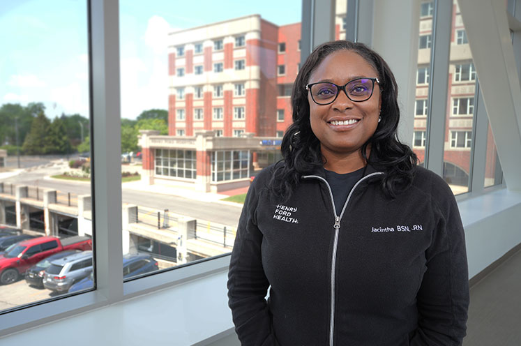 woman with henry ford hospital in background