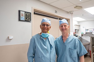 Dr Menon and Dr Rogers standing in the hallway in the hospital