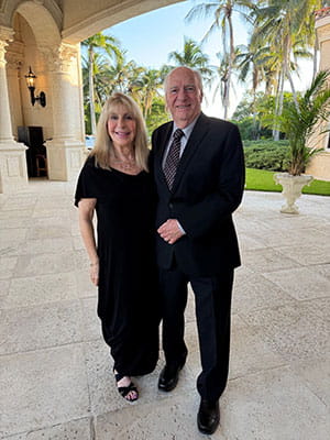 Eric and Ellen Prevost pose for photo at formal event.