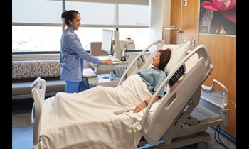 Alliance nurse in a room with a patient