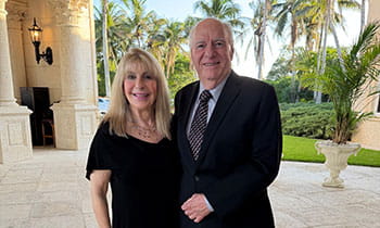 Eric and Ellen Prevost pose for photo at formal event.
