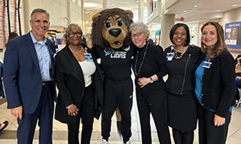 Dawn Treloar with group of people and Rory the Lion