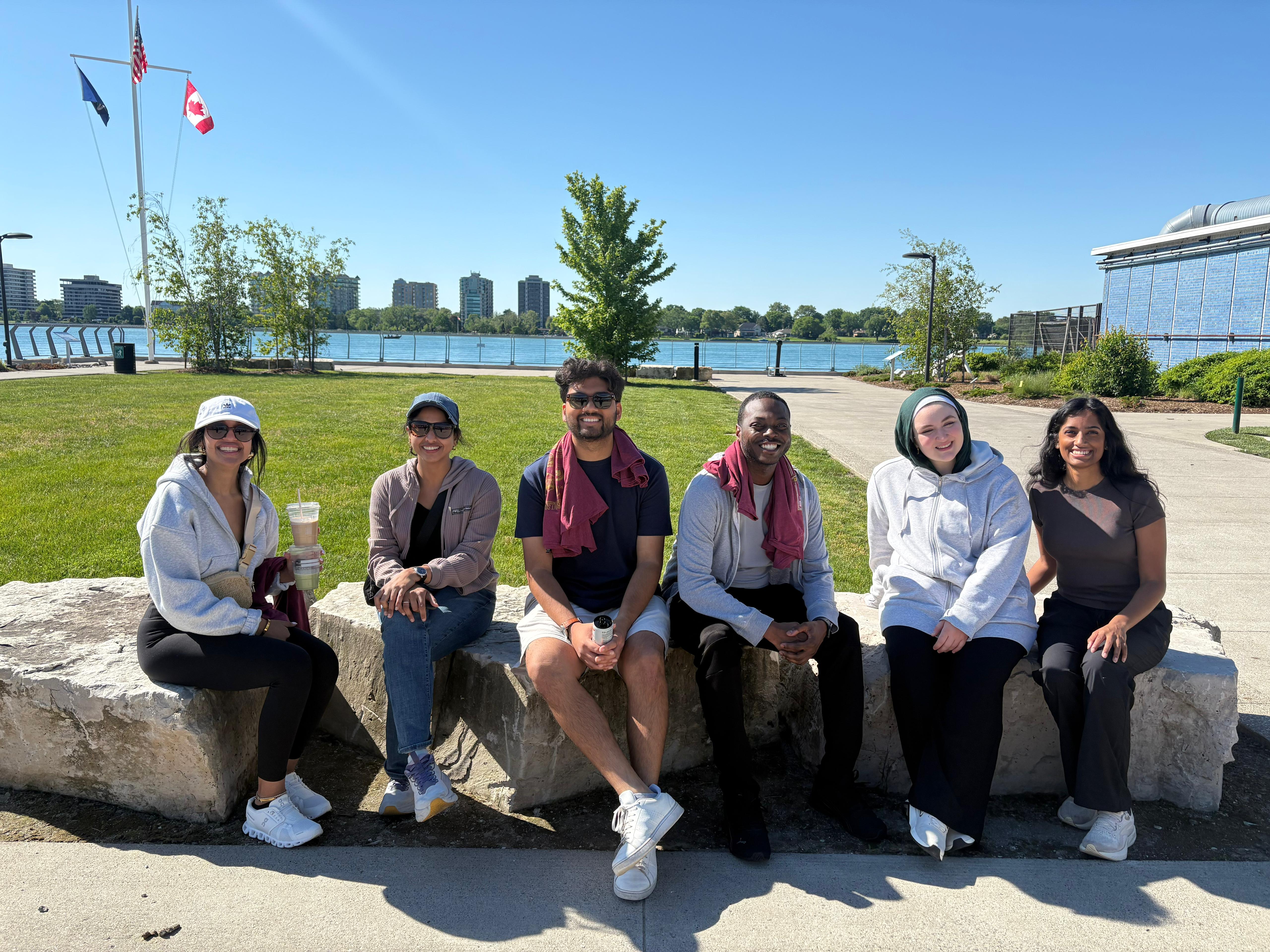 Residents on Belle Isle posed for group photo on bench.