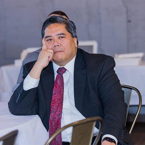 Dr Santos sitting at an event