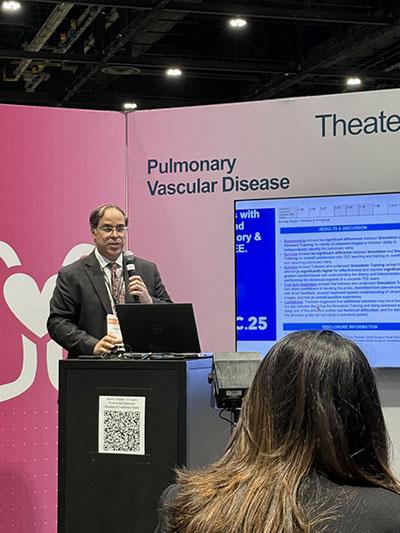 Fellow giving talk at podium