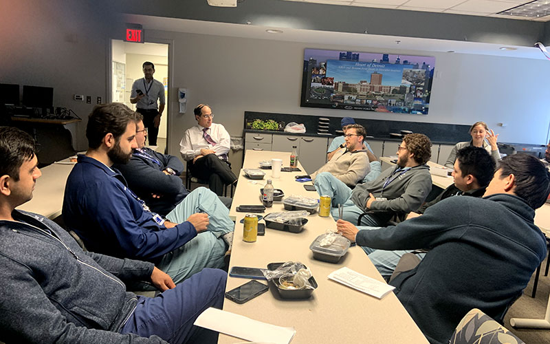 Fellows in classroom in conversation