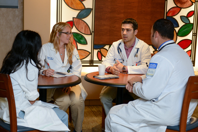 Residents talking around tables