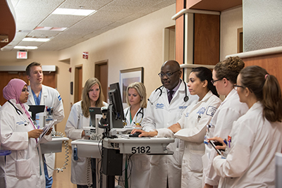 group of residents gathered around computer