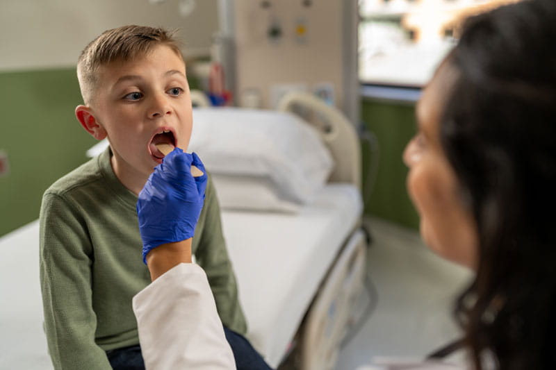 Provider looking into a pediatric patient's mouth