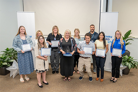 Nursing team holding up awards