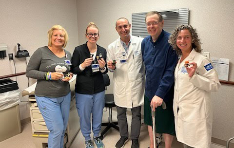 Michael standing with Henry Ford doctors and care team.