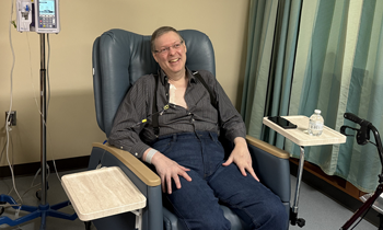 Patient Michael in the hospital sitting in a chair.