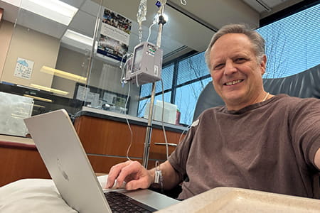 head and neck cancer patient joe smiling in the hospital bed