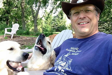 head and neck cancer patient joe posed with his dogs