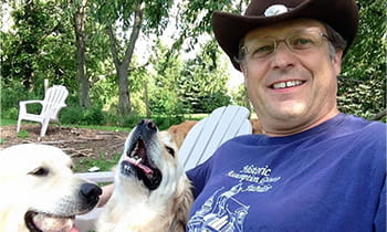 head and neck cancer patient joe posed with his dogs