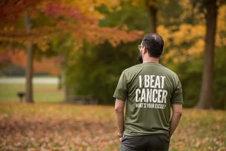 Shaun wearing shirt with text: I Beat Cancer What's Your Excuse?