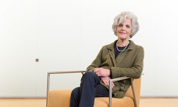 Pancreatic cancer patient, Sheila, sitting in chair