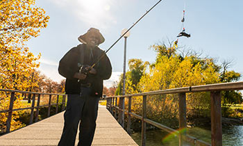 Prostate cancer patient, Dana, holding a fishing rod