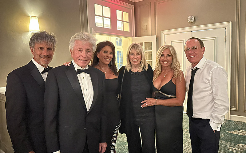 Heart surgery patient Cyril with group at a formal event