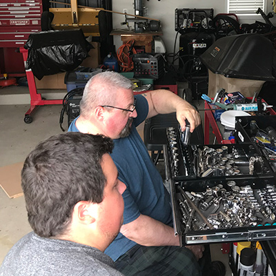 Dale and his son working on a car