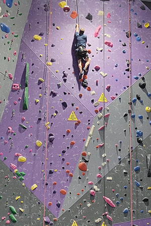 Eric doing indoor rock climbing