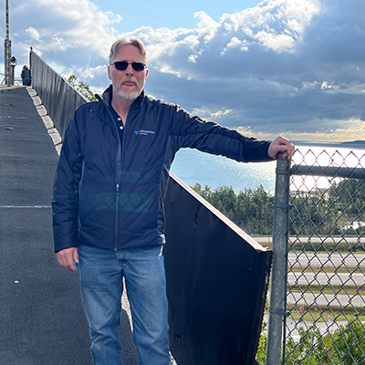 mike posed on a bridge outdoors