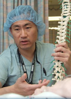 Man holding artificial spine