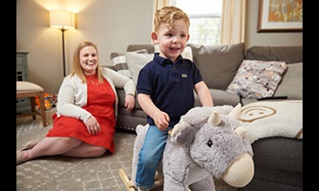 Ellie and her son, Beau, playing in family room