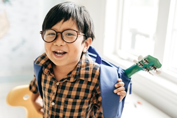 young boy with black glasses