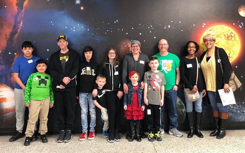 children with their parents at the planetarium