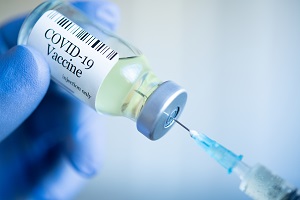 Getty Images photo of a vile of the COVID-19 vaccine getting loaded into a syringe. 
